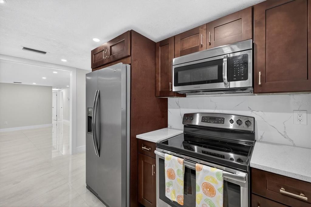 Interior, Kitchen, Marble Walls, Recessed Lighting, Stainless Steel Appliances
