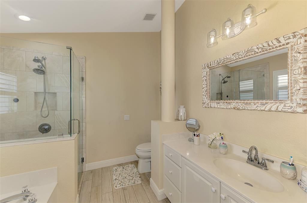 Bathroom, Dual Sink Vanities, Glass Shower, Interior, Recessed Lighting, Wood Texture Flooring