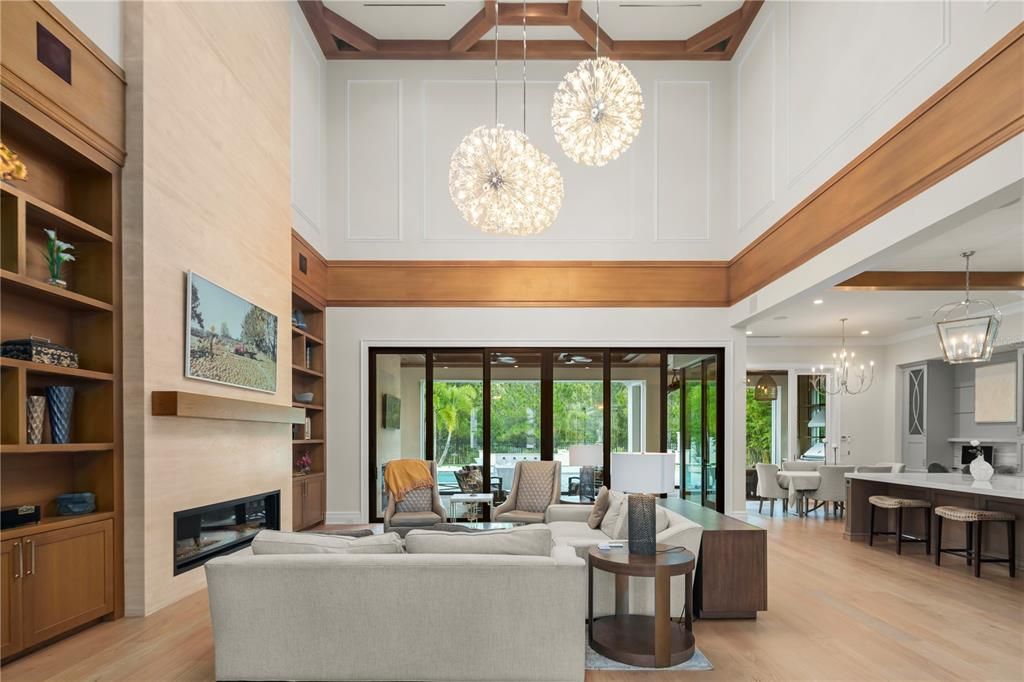 Chandelier, Dining room, Fireplace, Interior, Living room, Pendant Lights, Recessed Lighting, Wooden Beams, Wood Texture Flooring