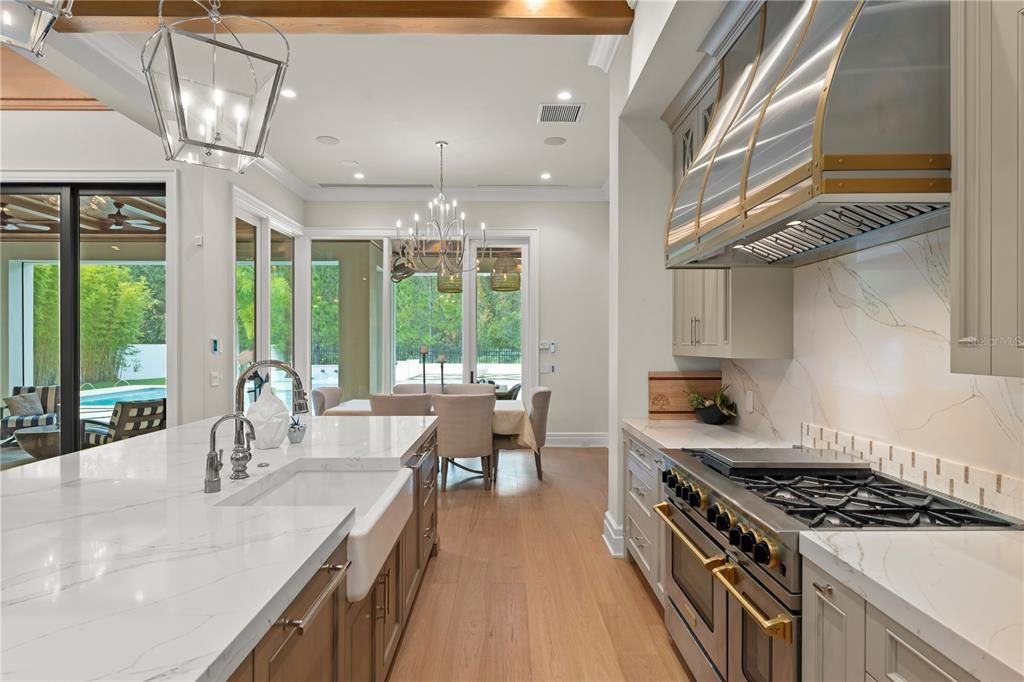 Chandelier, Dining room, Interior, Kitchen, Marble Walls, Recessed Lighting, Stainless Steel Appliances, Wood Texture Flooring