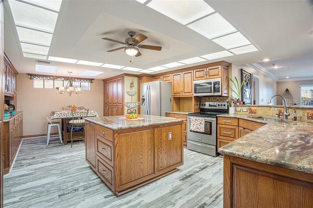 Chandelier, Dining room, Interior, Kitchen, Recessed Lighting, Stainless Steel Appliances, Wood Texture Flooring
