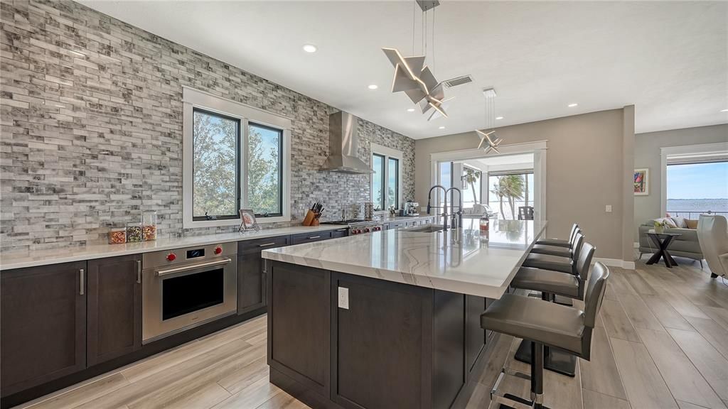 Interior, Kitchen, Pendant Lights, Recessed Lighting, Stainless Steel Appliances, Stone Walls, Water, Wood Texture Flooring