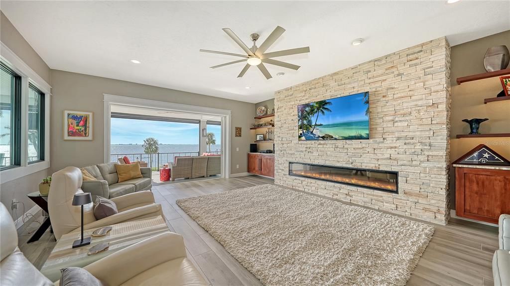 Fireplace, Interior, Living room, Recessed Lighting, Stone Walls, Water, Wood Texture Flooring