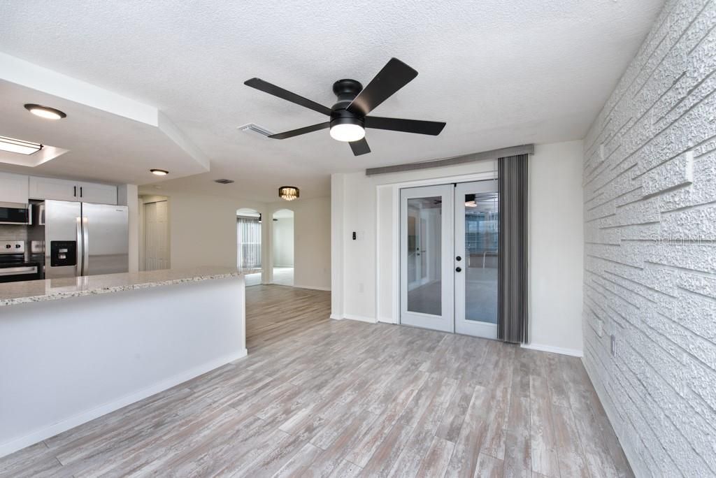 Empty room, Interior, Kitchen, Recessed Lighting, Stainless Steel Appliances, Stone Walls, Wood Texture Flooring