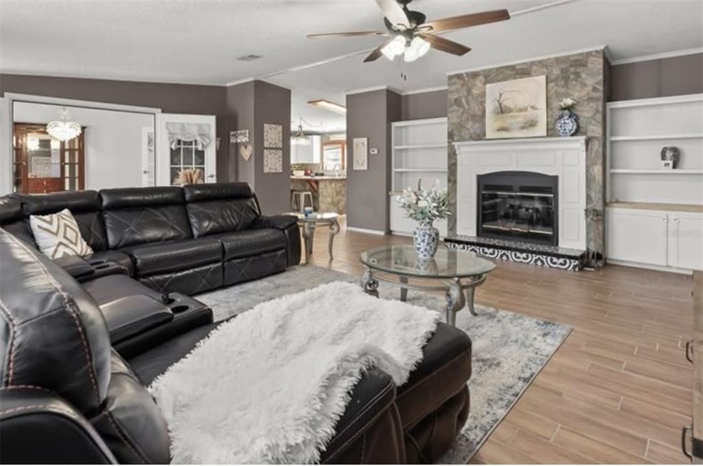 Chandelier, Fireplace, Interior, Living room, Stone Walls, Wood Texture Flooring