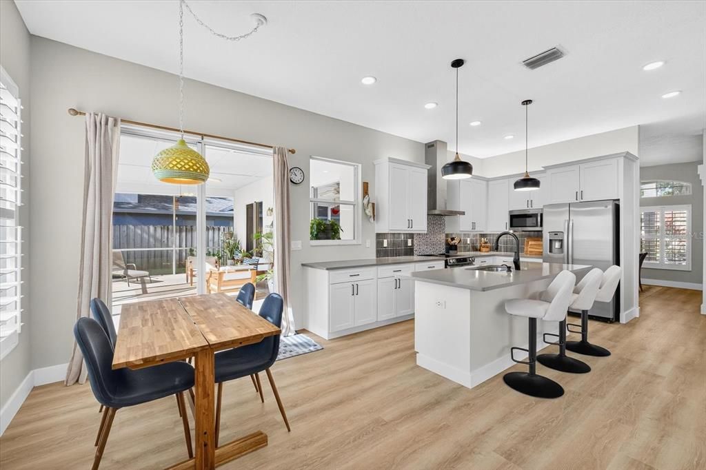 Dining room, Interior, Kitchen, Pendant Lights, Recessed Lighting, Stainless Steel Appliances, Wood Texture Flooring