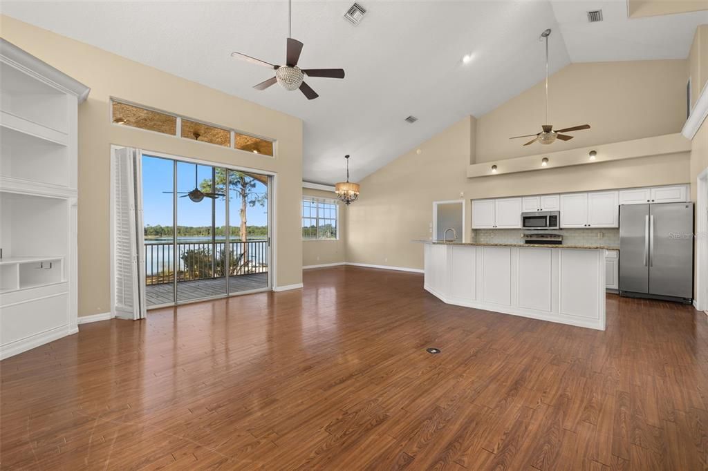Chandelier, Empty room, Interior, Kitchen, Pendant Lights, Recessed Lighting, Stainless Steel Appliances, Wood Texture Flooring