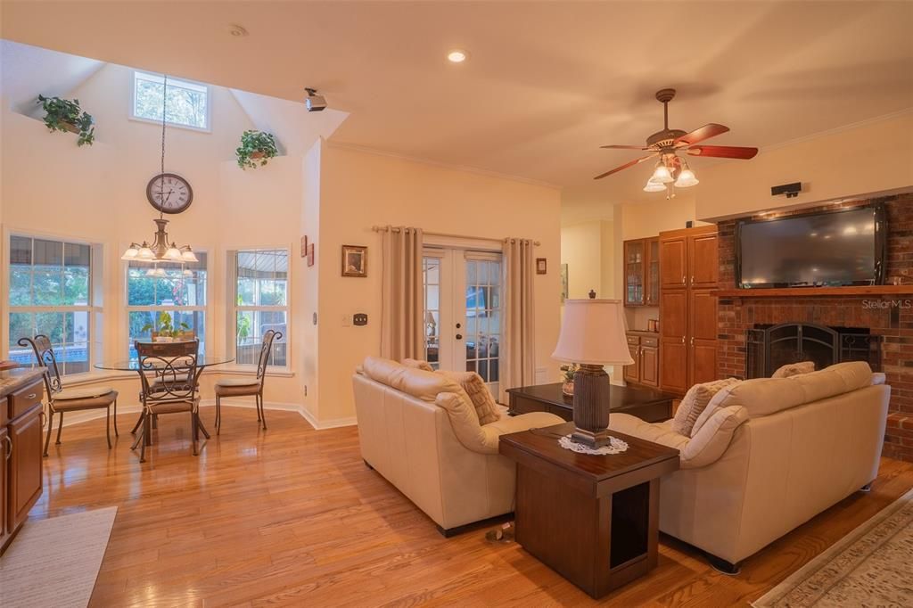 Dining room, Fireplace, Interior, Living room, Recessed Lighting, Wood Texture Flooring