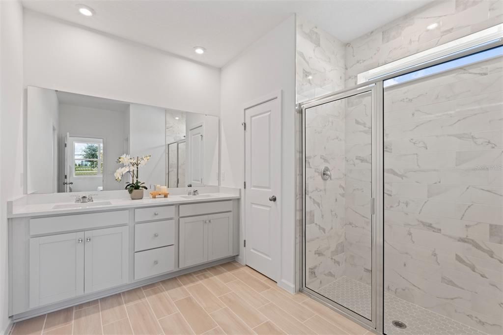 Bathroom, Dual Sink Vanities, Glass Shower, Interior, Marble Walls, Recessed Lighting, Wood Texture Flooring