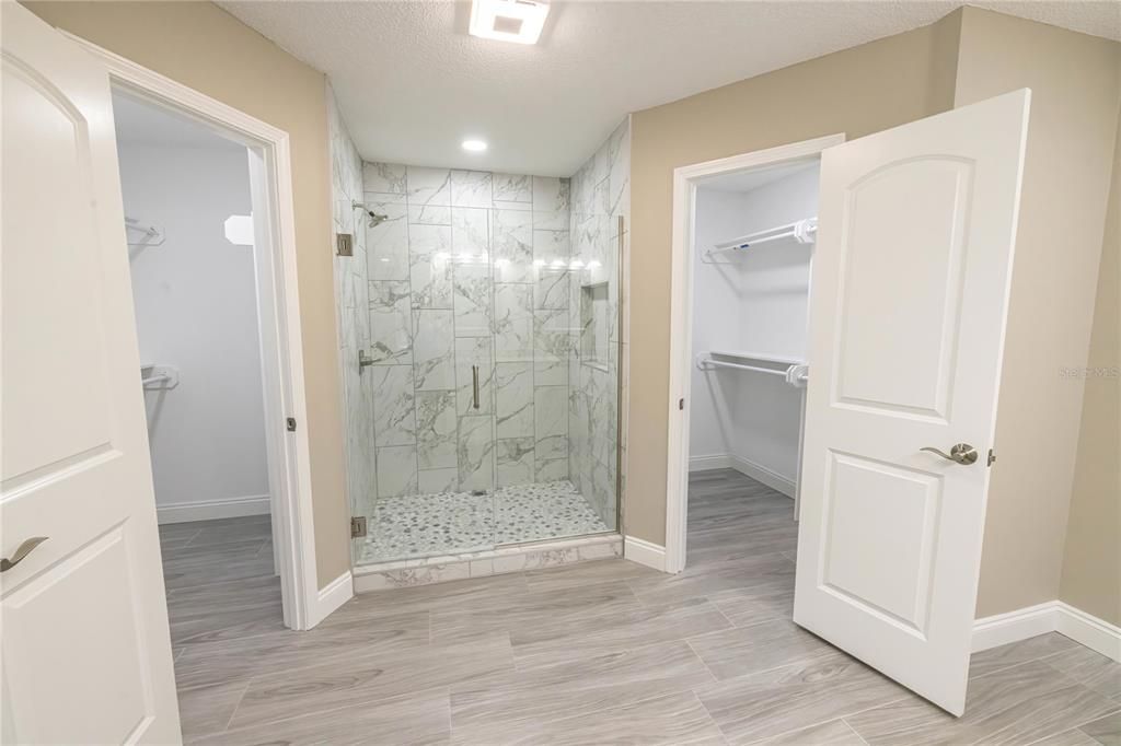 Bathroom, Glass Shower, Interior, Marble Walls, Recessed Lighting, Wood Texture Flooring