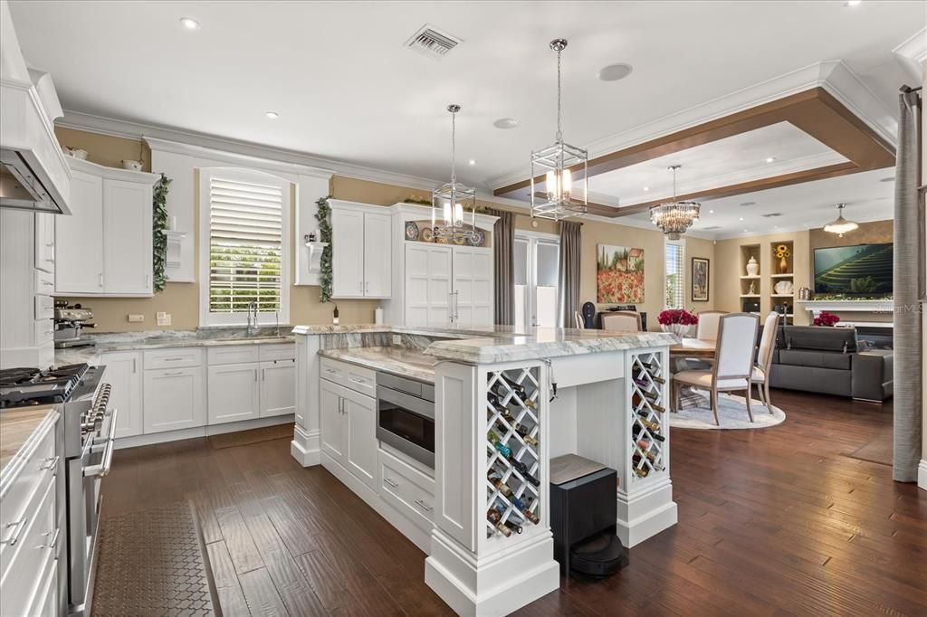 Chandelier, Dining room, Interior, Kitchen, Living room, Pendant Lights, Recessed Lighting, Stainless Steel Appliances, Wood Texture Flooring