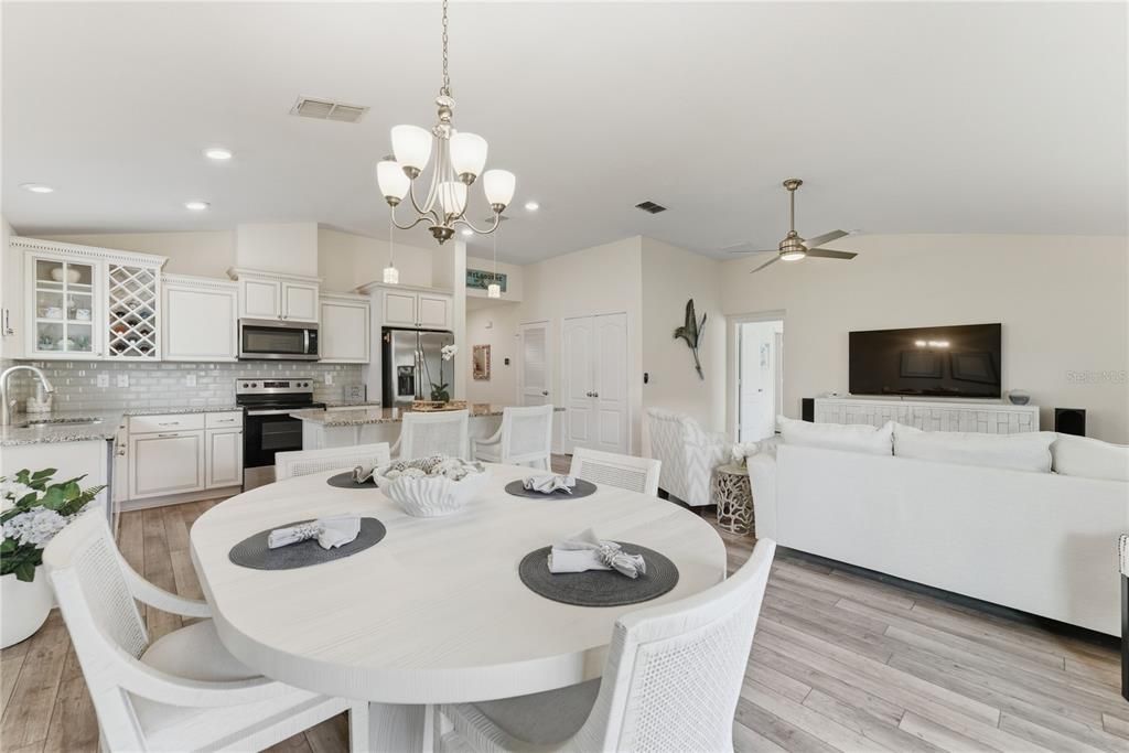 Chandelier, Dining room, Interior, Kitchen, Living room, Recessed Lighting, Stainless Steel Appliances, Wood Texture Flooring