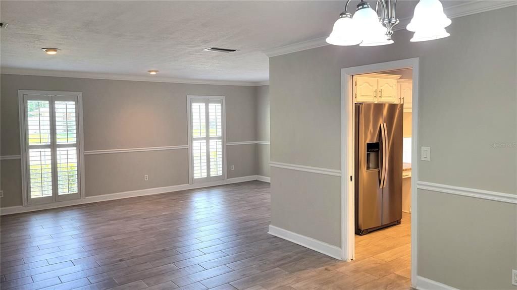 Empty room, Interior, Kitchen, Pendant Lights, Recessed Lighting, Stainless Steel Appliances, Wood Texture Flooring