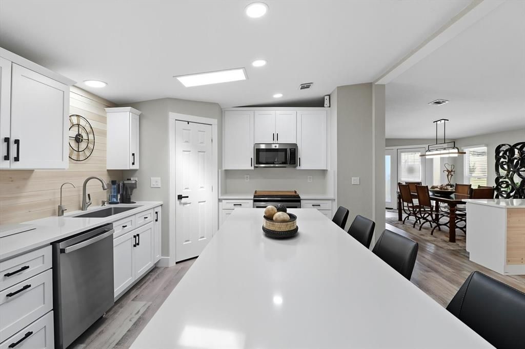 Dining room, Interior, Kitchen, Pendant Lights, Recessed Lighting, Stainless Steel Appliances, Wood Texture Flooring