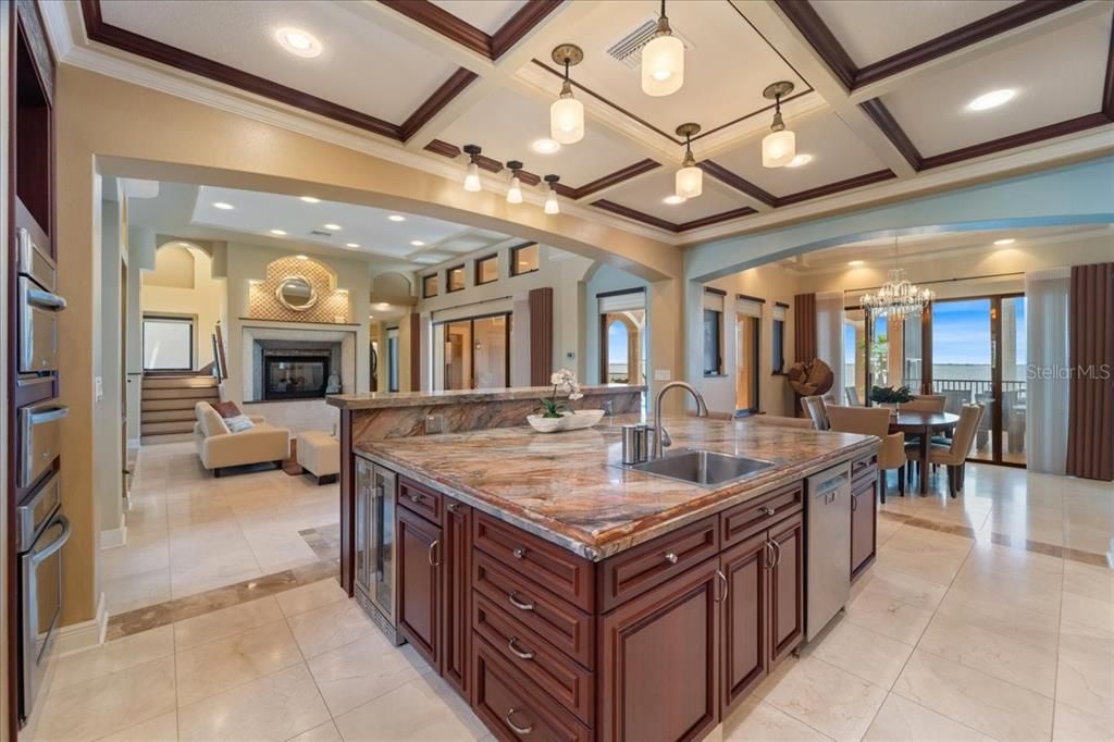 Chandelier, Dining room, Fireplace, Interior, Kitchen, Living room, Pendant Lights, Recessed Lighting, Stainless Steel Appliances, Water, Wooden Beams