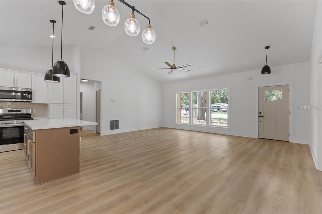 Empty room, Interior, Kitchen, Pendant Lights, Stainless Steel Appliances, Wood Texture Flooring
