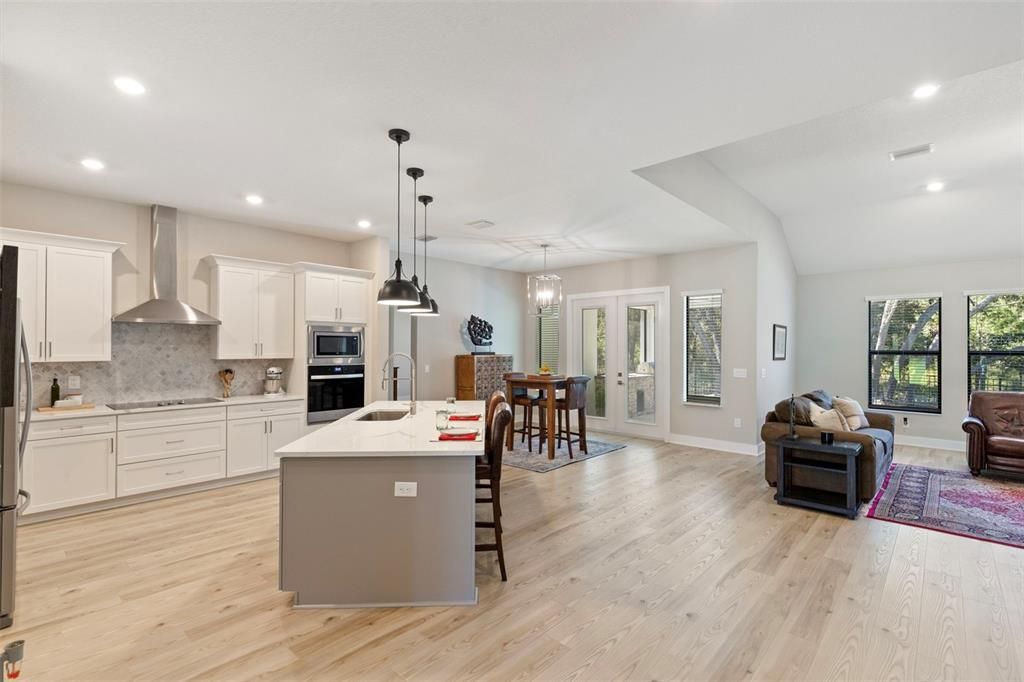 Dining room, Interior, Kitchen, Living room, Pendant Lights, Recessed Lighting, Stainless Steel Appliances, Wood Texture Flooring