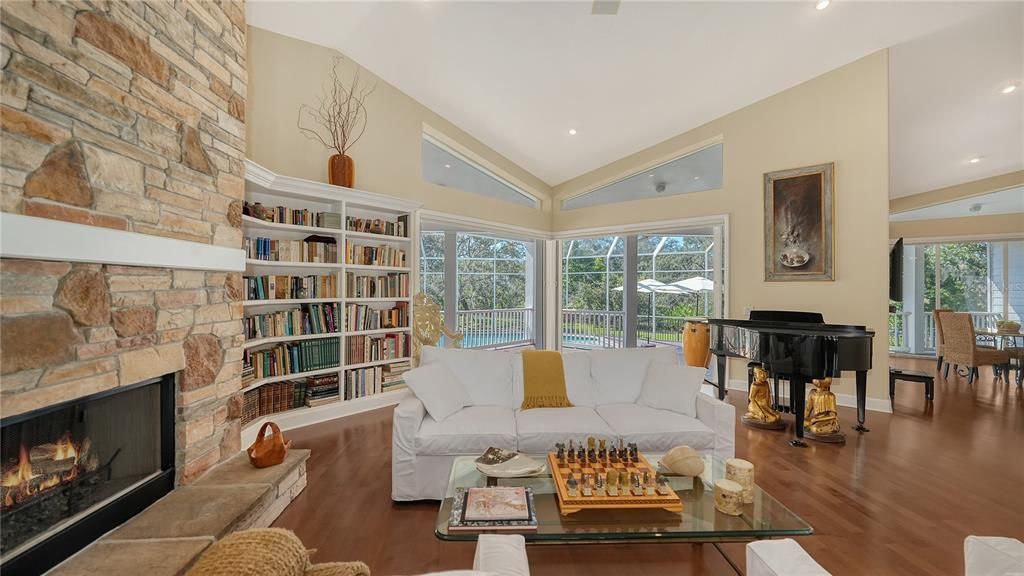 Fireplace, Interior, Living room, Piano, Recessed Lighting, Stone Walls, Wood Texture Flooring