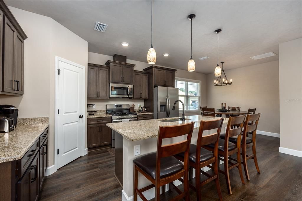 Dining room, Interior, Kitchen, Pendant Lights, Recessed Lighting, Stainless Steel Appliances, Wood Texture Flooring