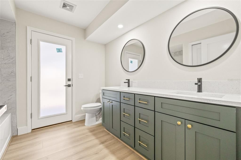 Bathroom, Dual Sink Vanities, Interior, Marble Walls, Recessed Lighting, Wood Texture Flooring