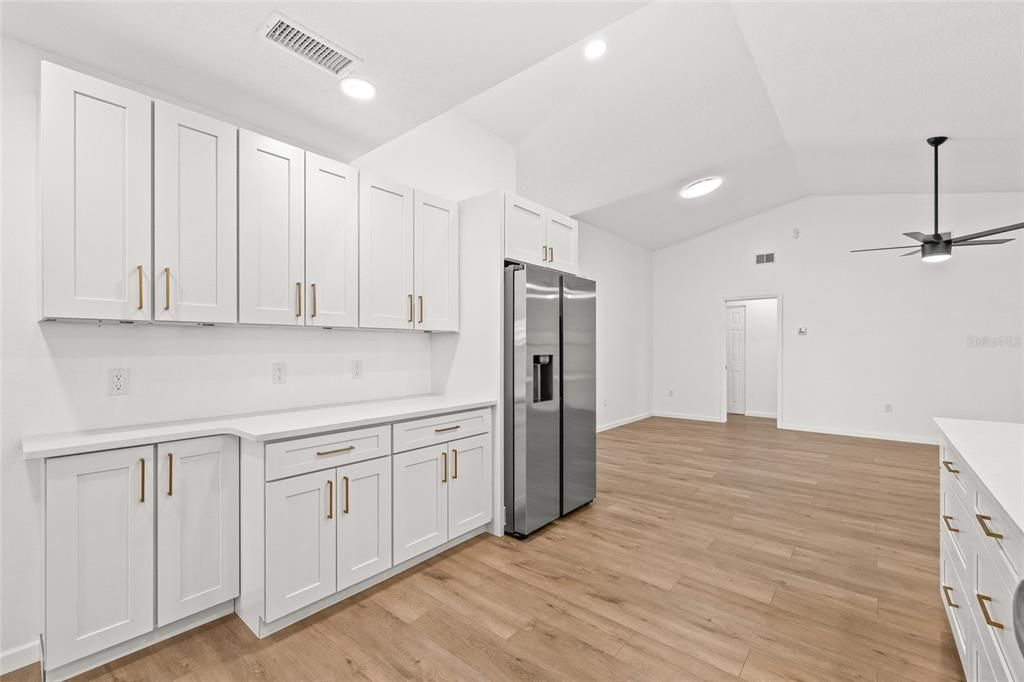 Empty room, Interior, Kitchen, Recessed Lighting, Stainless Steel Appliances, Wood Texture Flooring