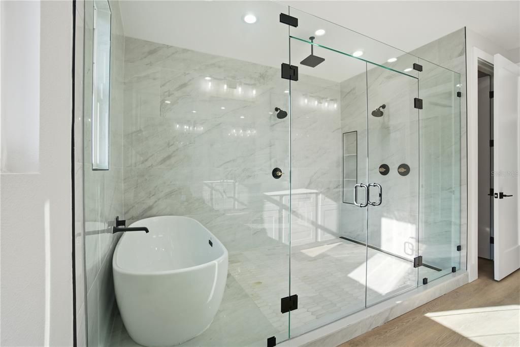 Bathroom, Free Standing Baths, Glass Shower, Interior, Marble Walls, Recessed Lighting, Wood Texture Flooring