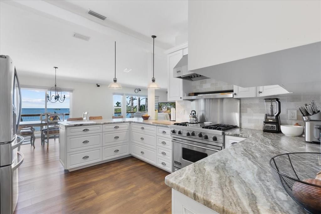 Chandelier, Dining room, Interior, Kitchen, Pendant Lights, Stainless Steel Appliances, Water, Wood Texture Flooring