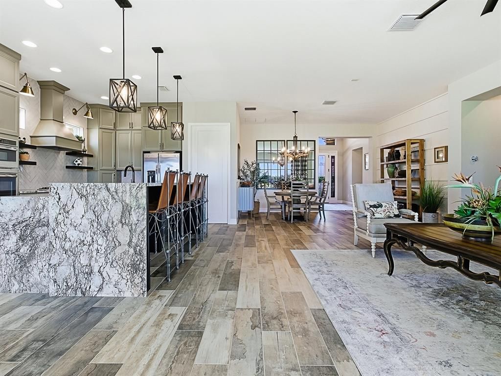 Chandelier, Dining room, Interior, Kitchen, Pendant Lights, Recessed Lighting, Stainless Steel Appliances, Wood Texture Flooring