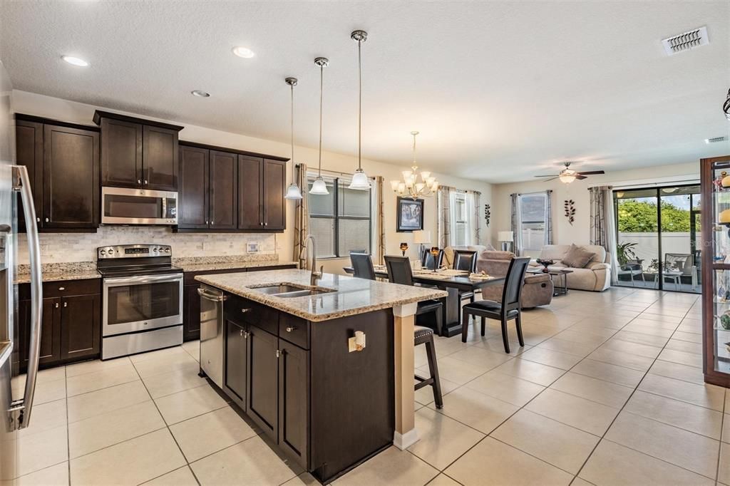 Chandelier, Dining room, Interior, Kitchen, Living room, Pendant Lights, Recessed Lighting, Stainless Steel Appliances