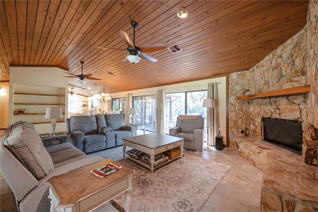 Chandelier, Dining room, Fireplace, Interior, Living room, Pendant Lights, Recessed Lighting, Stone Walls, Wooden Ceilings