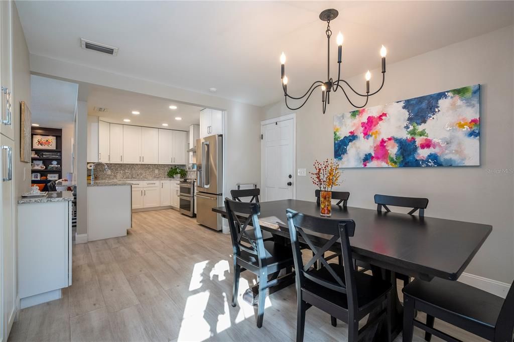 Chandelier, Dining room, Interior, Kitchen, Recessed Lighting, Stainless Steel Appliances, Wood Texture Flooring