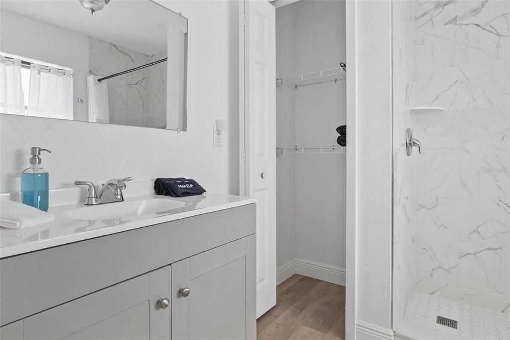 Bathroom, Glass Shower, Interior, Marble Walls, Wood Texture Flooring