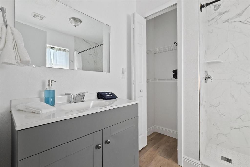 Bathroom, Glass Shower, Interior, Marble Walls, Wood Texture Flooring