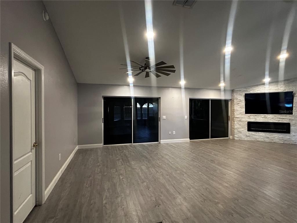 Empty room, Fireplace, Interior, Recessed Lighting, Stone Walls, Wood Texture Flooring