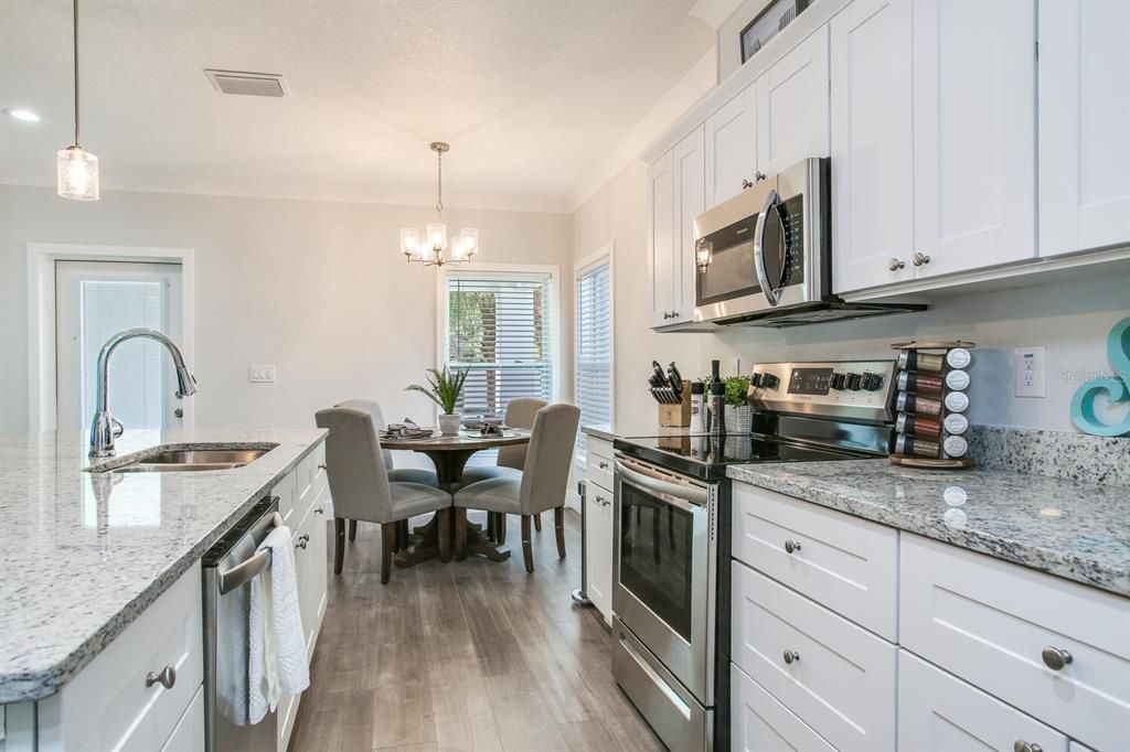 Chandelier, Dining room, Interior, Kitchen, Pendant Lights, Recessed Lighting, Stainless Steel Appliances, Wood Texture Flooring