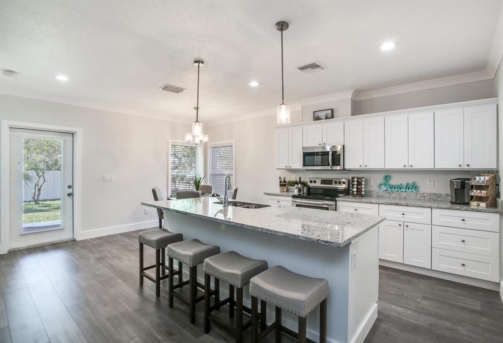 Dining room, Interior, Kitchen, Pendant Lights, Recessed Lighting, Stainless Steel Appliances, Wood Texture Flooring