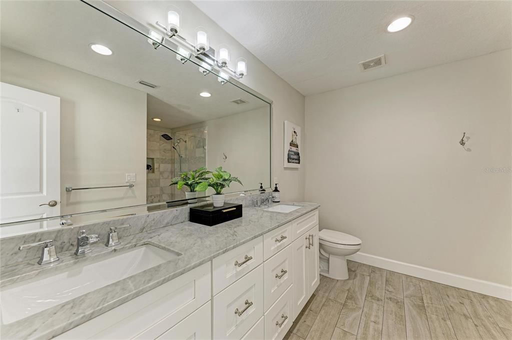 Bathroom, Dual Sink Vanities, Glass Shower, Interior, Recessed Lighting, Wood Texture Flooring