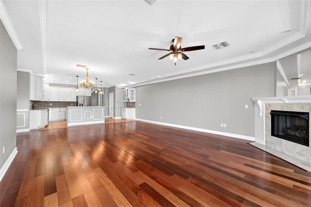 Empty room, Fireplace, Interior, Kitchen, Pendant Lights, Recessed Lighting, Wood Texture Flooring