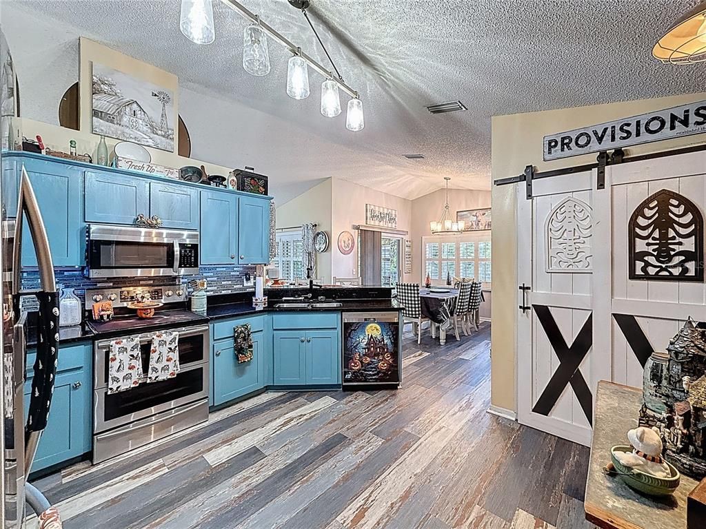 Chandelier, Dining room, Interior, Kitchen, Pendant Lights, Stainless Steel Appliances, Wood Texture Flooring