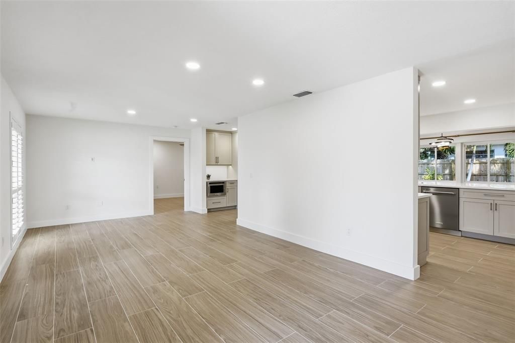 Empty room, Interior, Kitchen, Recessed Lighting, Stainless Steel Appliances, Wood Texture Flooring