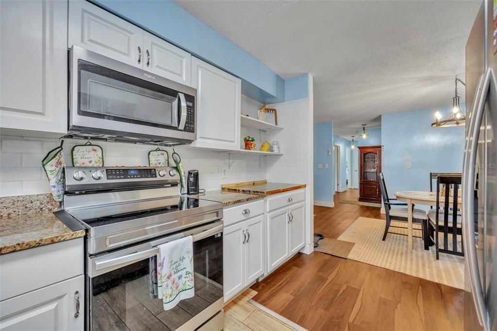 Dining room, Interior, Kitchen, Pendant Lights, Stainless Steel Appliances, Wood Texture Flooring