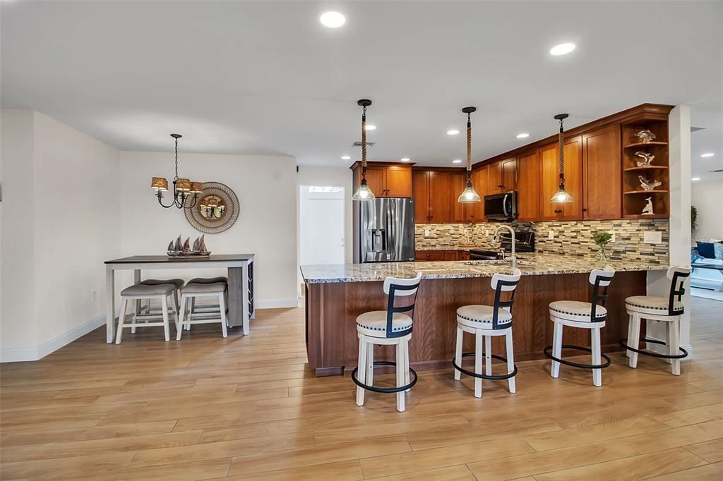 Dining room, Interior, Kitchen, Pendant Lights, Recessed Lighting, Stainless Steel Appliances, Wood Texture Flooring