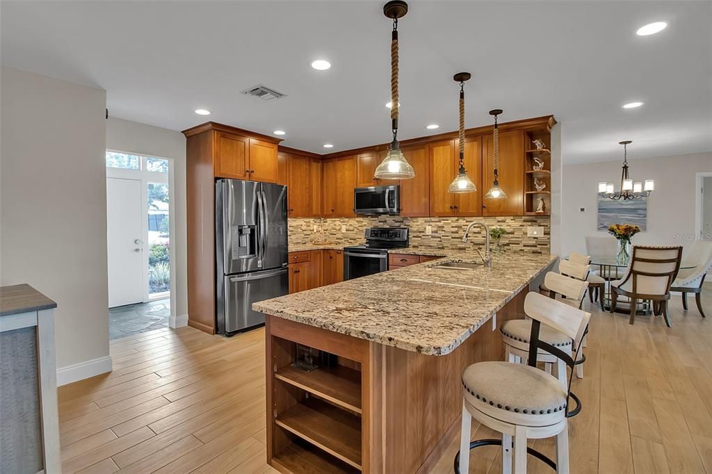 Chandelier, Dining room, Interior, Kitchen, Pendant Lights, Recessed Lighting, Stainless Steel Appliances, Wood Texture Flooring