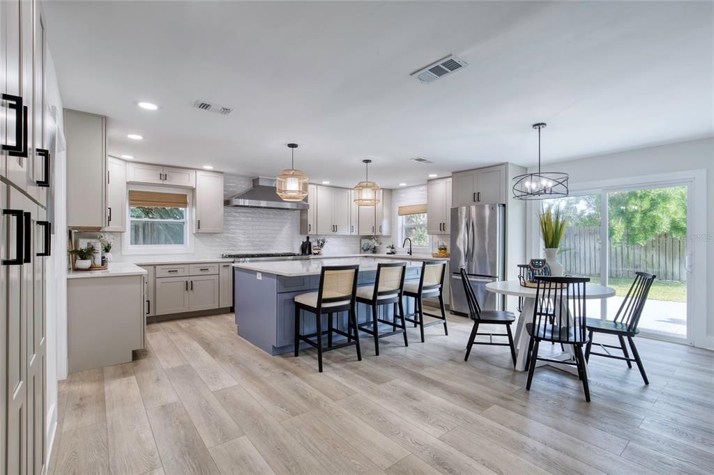 Dining room, Interior, Kitchen, Pendant Lights, Recessed Lighting, Stainless Steel Appliances, Wood Texture Flooring