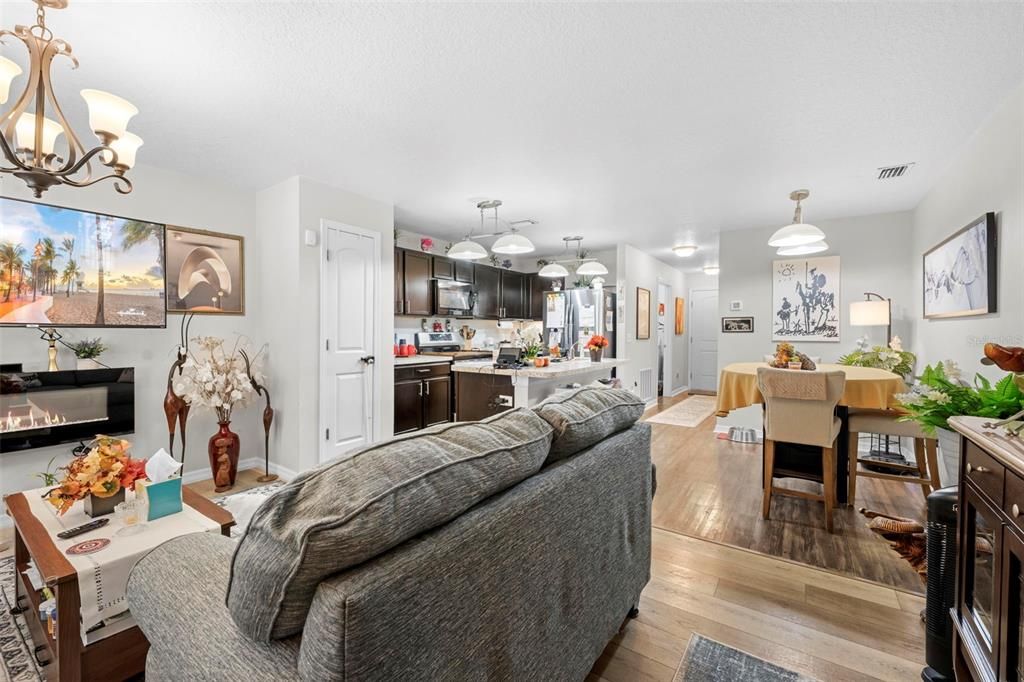 Chandelier, Dining room, Fireplace, Interior, Kitchen, Living room, Pendant Lights, Wood Texture Flooring