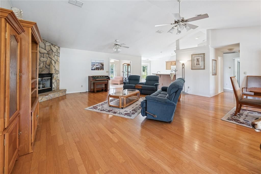 Dining room, Fireplace, Interior, Living room, Recessed Lighting, Stone Walls, Wood Texture Flooring
