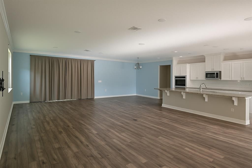 Empty room, Interior, Kitchen, Recessed Lighting, Stainless Steel Appliances, Wood Texture Flooring