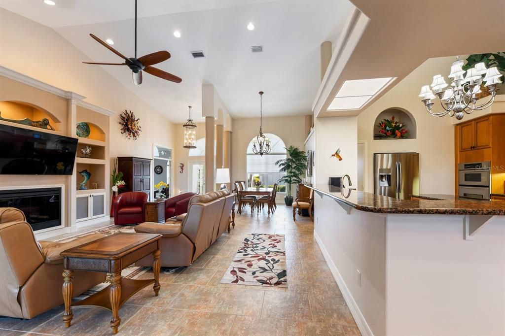 Chandelier, Dining room, Fireplace, Interior, Kitchen, Living room, Pendant Lights, Recessed Lighting, Stainless Steel Appliances