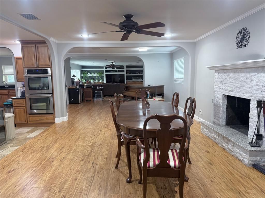 Dining room, Fireplace, Interior, Kitchen, Recessed Lighting, Wood Texture Flooring