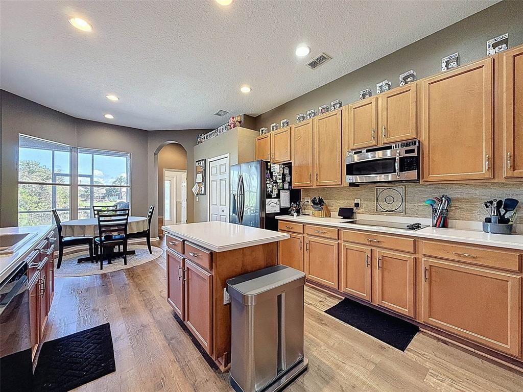 Dining room, Interior, Kitchen, Recessed Lighting, Stainless Steel Appliances, Wood Texture Flooring